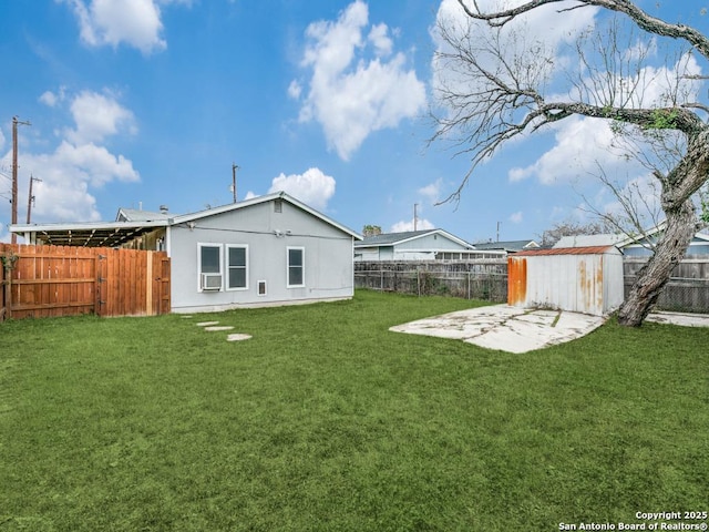 back of property featuring a yard, a patio, and a shed