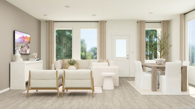 sitting room with light wood-type flooring and a wealth of natural light