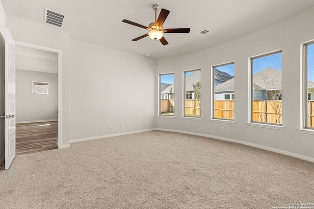 carpeted empty room featuring ceiling fan