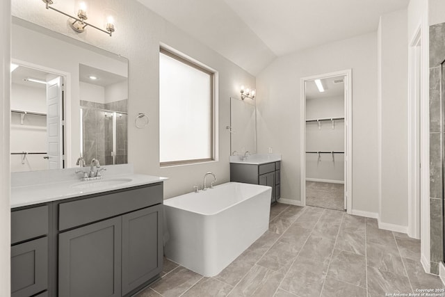 bathroom featuring vanity and independent shower and bath