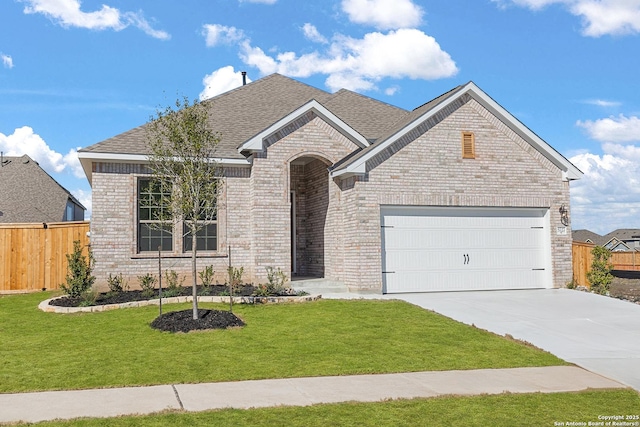 view of front of house featuring a garage and a front yard