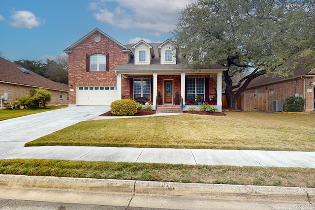 view of front of house featuring central AC unit, covered porch, a front yard, and a garage