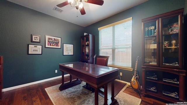 home office featuring ceiling fan and dark wood-type flooring