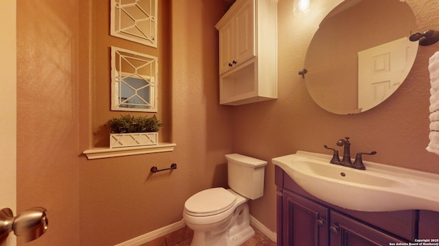 bathroom featuring tile patterned floors, vanity, and toilet