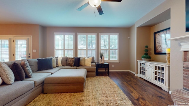 living room with ceiling fan, dark hardwood / wood-style flooring, and a brick fireplace