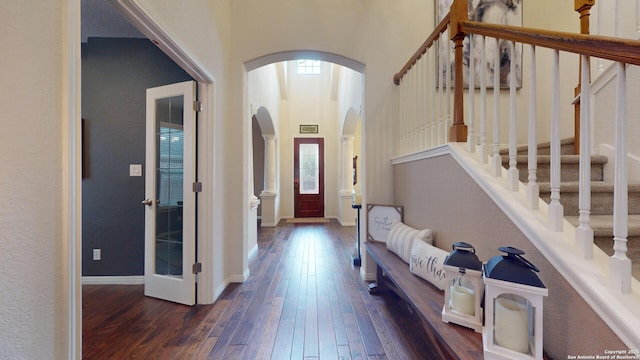 foyer featuring dark hardwood / wood-style floors and a high ceiling