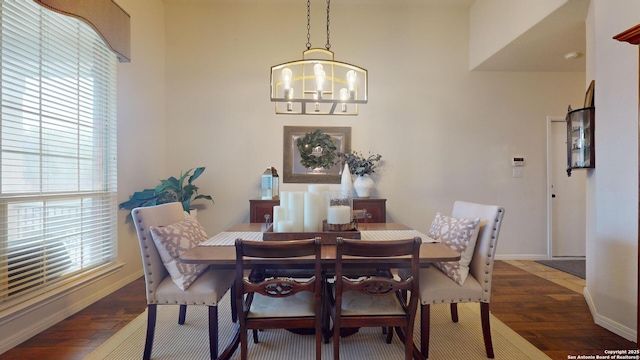 dining room featuring dark wood-type flooring and a chandelier