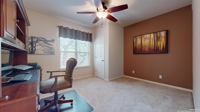 carpeted office space featuring ceiling fan