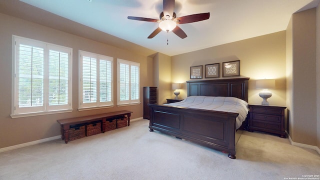 bedroom with ceiling fan and light carpet