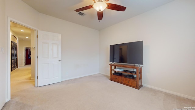 living room with ceiling fan and light colored carpet