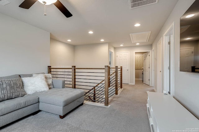 living room with light colored carpet and ceiling fan