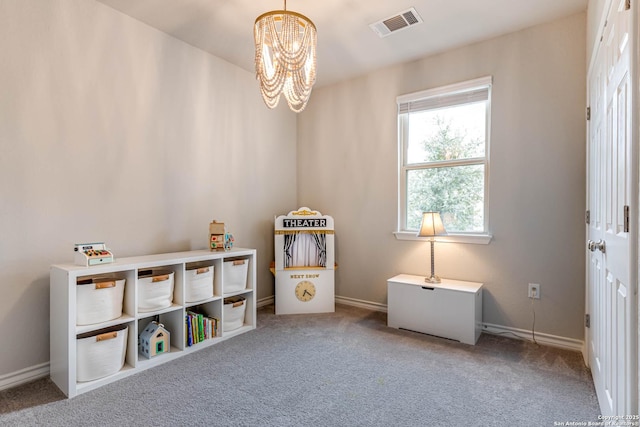 game room with carpet and a chandelier