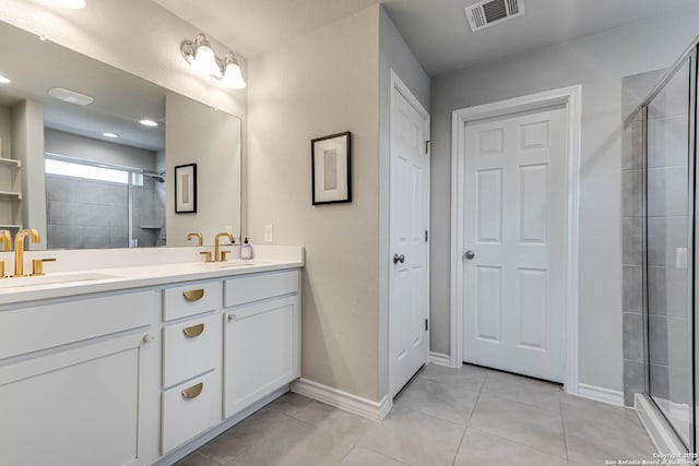 bathroom with tile patterned flooring, vanity, and an enclosed shower