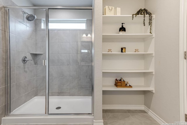 bathroom with tile patterned flooring and a shower with shower door