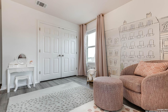 sitting room with wood-type flooring