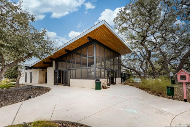 view of property exterior featuring a sunroom