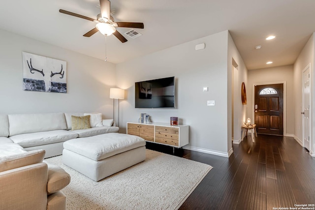 living room with dark hardwood / wood-style floors and ceiling fan