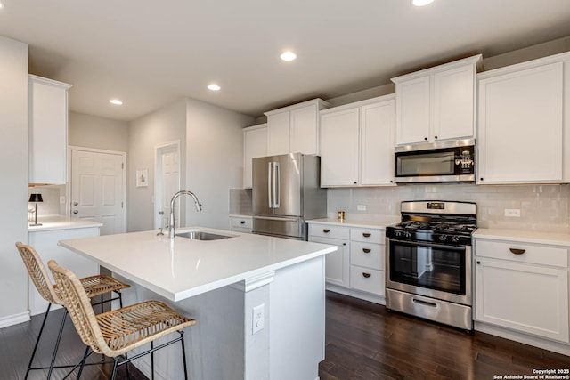 kitchen with sink, white cabinets, and appliances with stainless steel finishes