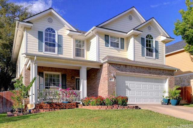 view of front facade with a front yard, a garage, and a porch