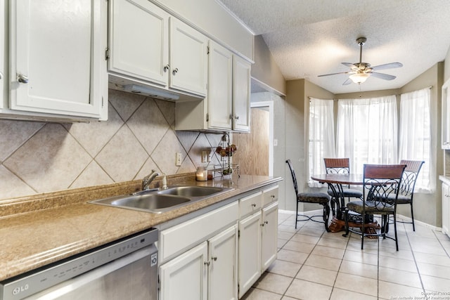 kitchen with white cabinetry, sink, ceiling fan, stainless steel dishwasher, and a textured ceiling