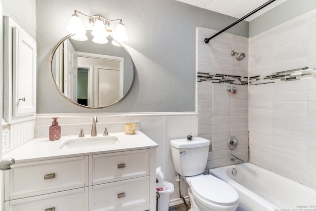 full bathroom with vanity, toilet, and tiled shower / bath