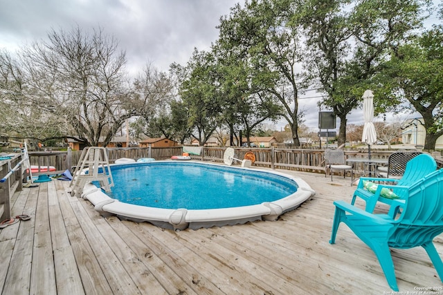 view of swimming pool featuring a deck