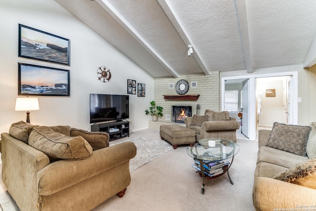 living room featuring lofted ceiling with beams, light colored carpet, a textured ceiling, and a brick fireplace