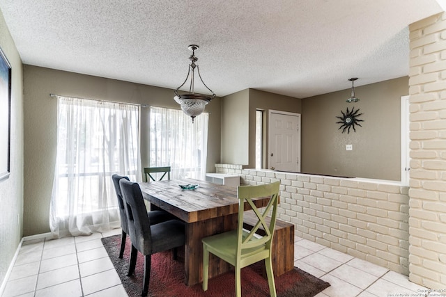 tiled dining room with a textured ceiling