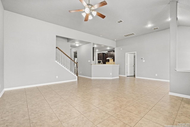 unfurnished living room featuring ceiling fan and light tile patterned flooring