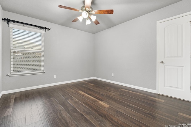 empty room with ceiling fan and dark wood-type flooring