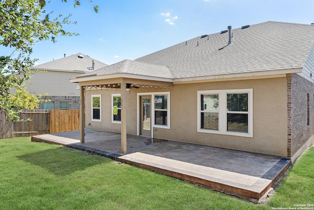 back of house featuring ceiling fan, a yard, and a patio