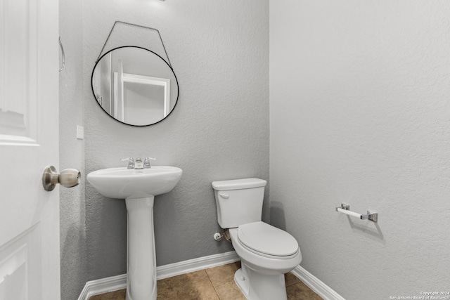 bathroom featuring tile patterned floors, toilet, and sink