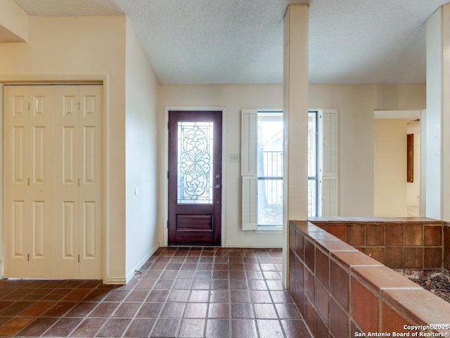 foyer entrance with a textured ceiling