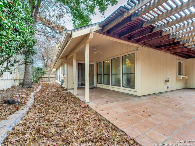 rear view of property featuring a patio area and ceiling fan