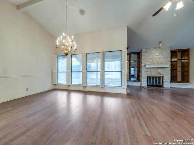 unfurnished living room with a stone fireplace, ceiling fan with notable chandelier, high vaulted ceiling, beamed ceiling, and wood-type flooring