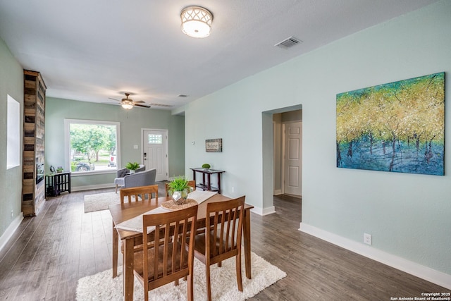 dining area with dark hardwood / wood-style flooring and ceiling fan