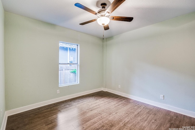 unfurnished room featuring dark hardwood / wood-style floors and ceiling fan