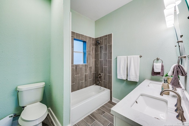 full bathroom with vanity, toilet, and tiled shower / bath