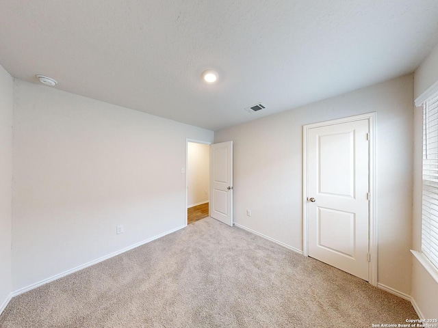 unfurnished bedroom featuring light colored carpet