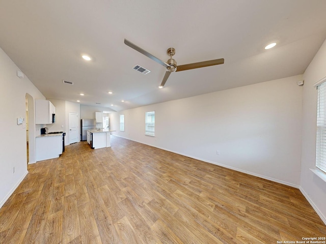 unfurnished living room with ceiling fan and light hardwood / wood-style flooring