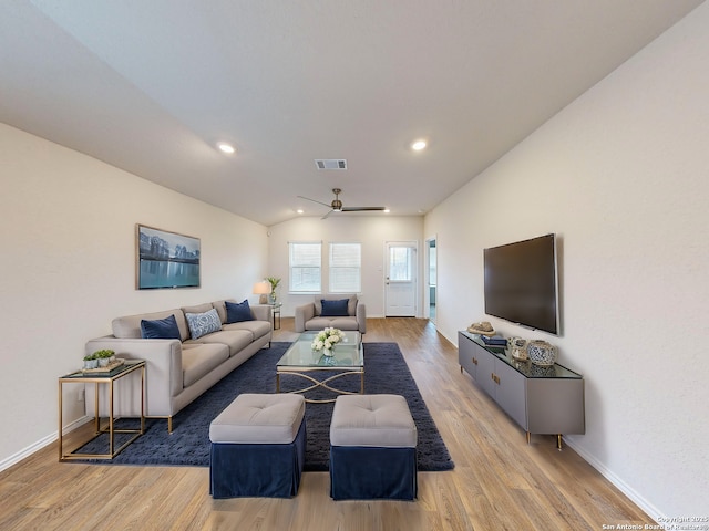 living room featuring light wood-type flooring, ceiling fan, and lofted ceiling