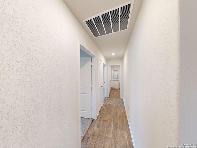 corridor featuring light hardwood / wood-style floors