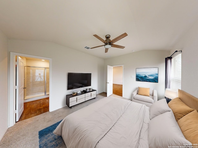 bedroom with ensuite bathroom, vaulted ceiling, and ceiling fan