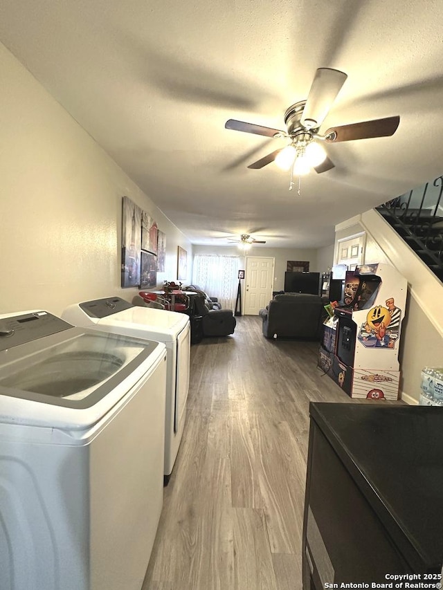 washroom featuring hardwood / wood-style flooring, washer and dryer, and ceiling fan