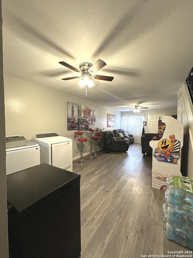 bedroom with washer and dryer, hardwood / wood-style floors, a textured ceiling, and ceiling fan