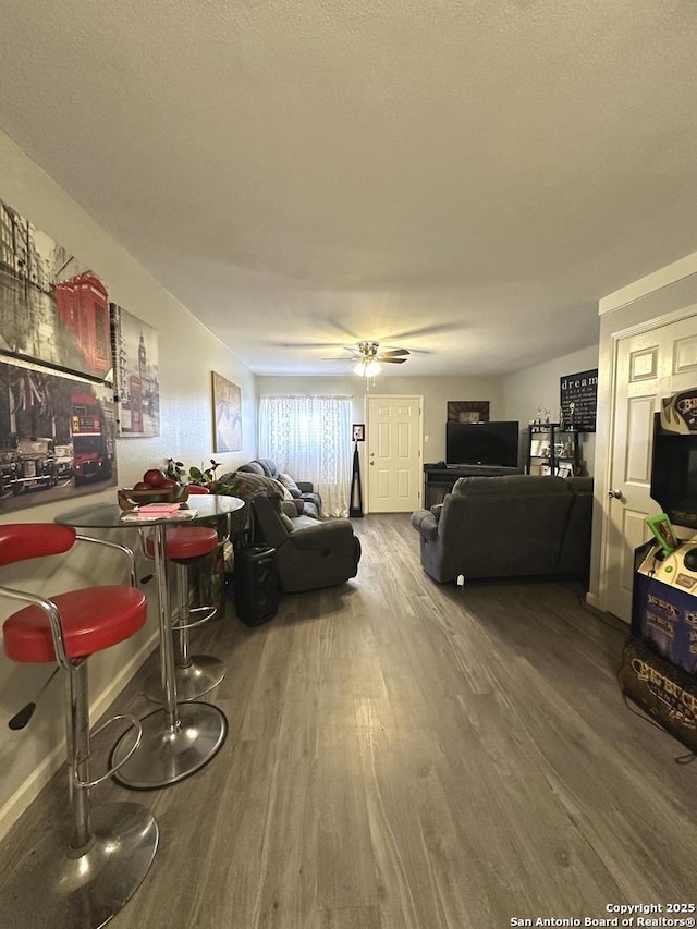 living room featuring ceiling fan and wood-type flooring