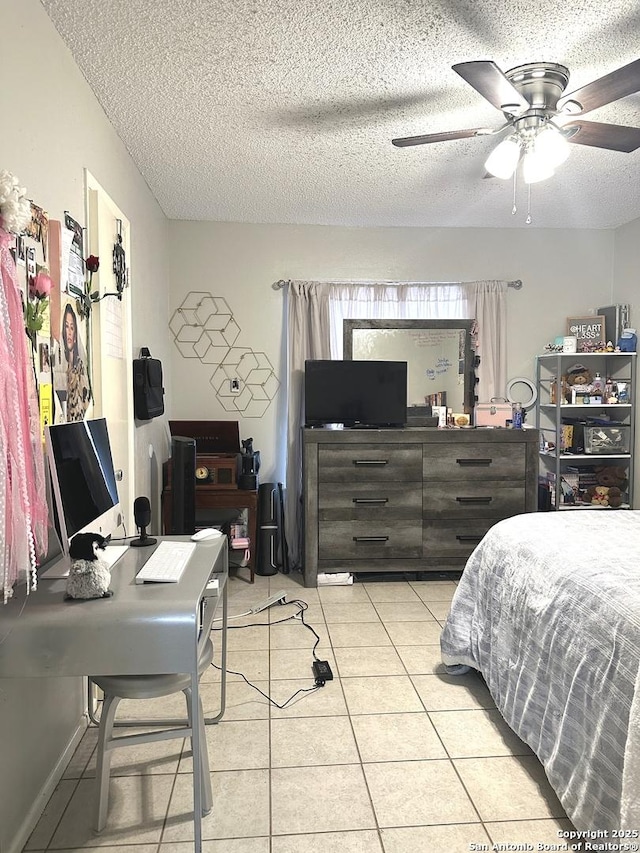 tiled bedroom with ceiling fan and a textured ceiling