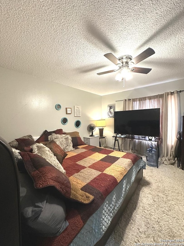 bedroom with carpet, a textured ceiling, and ceiling fan