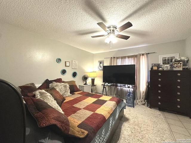 tiled bedroom with ceiling fan and a textured ceiling