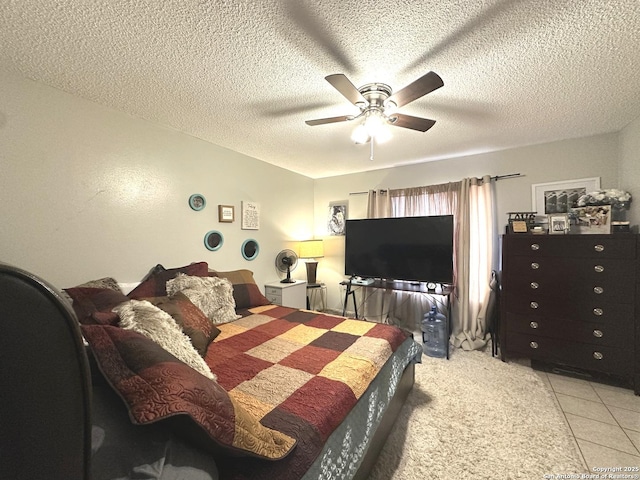 tiled bedroom featuring a textured ceiling and ceiling fan